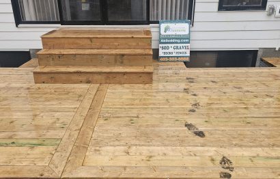Newly built wooden backyard deck with stairs at a residential home